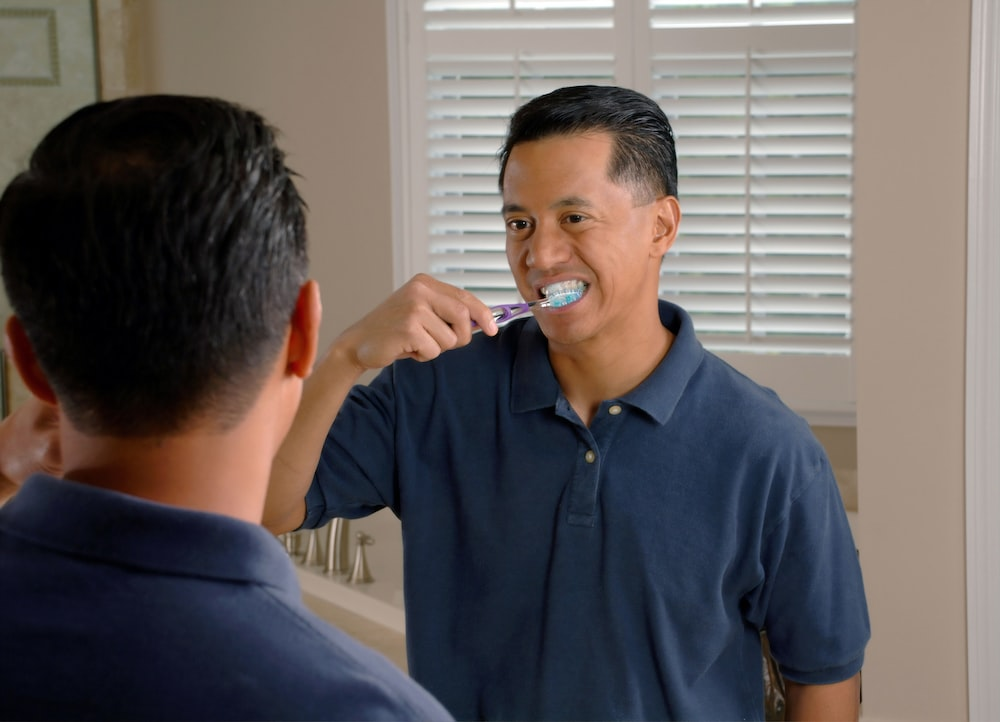 a man brushing teeth